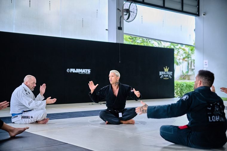 BJJ coaches and students seated for instruction on the mats at Superpro Samui, Koh Samui