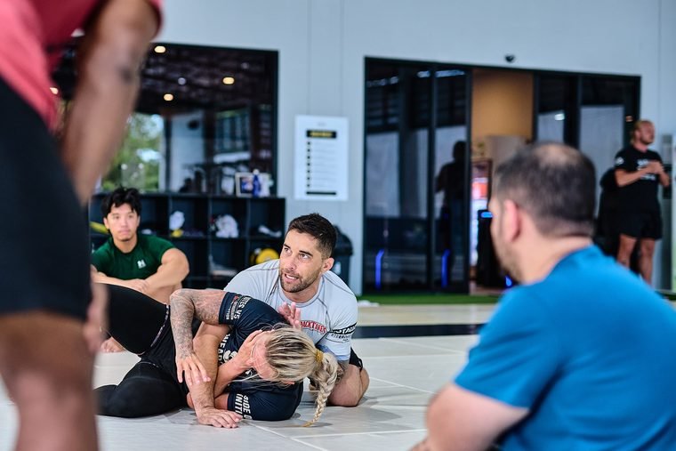 No-Gi grappling class watching a technique demonstration at Superpro Samui