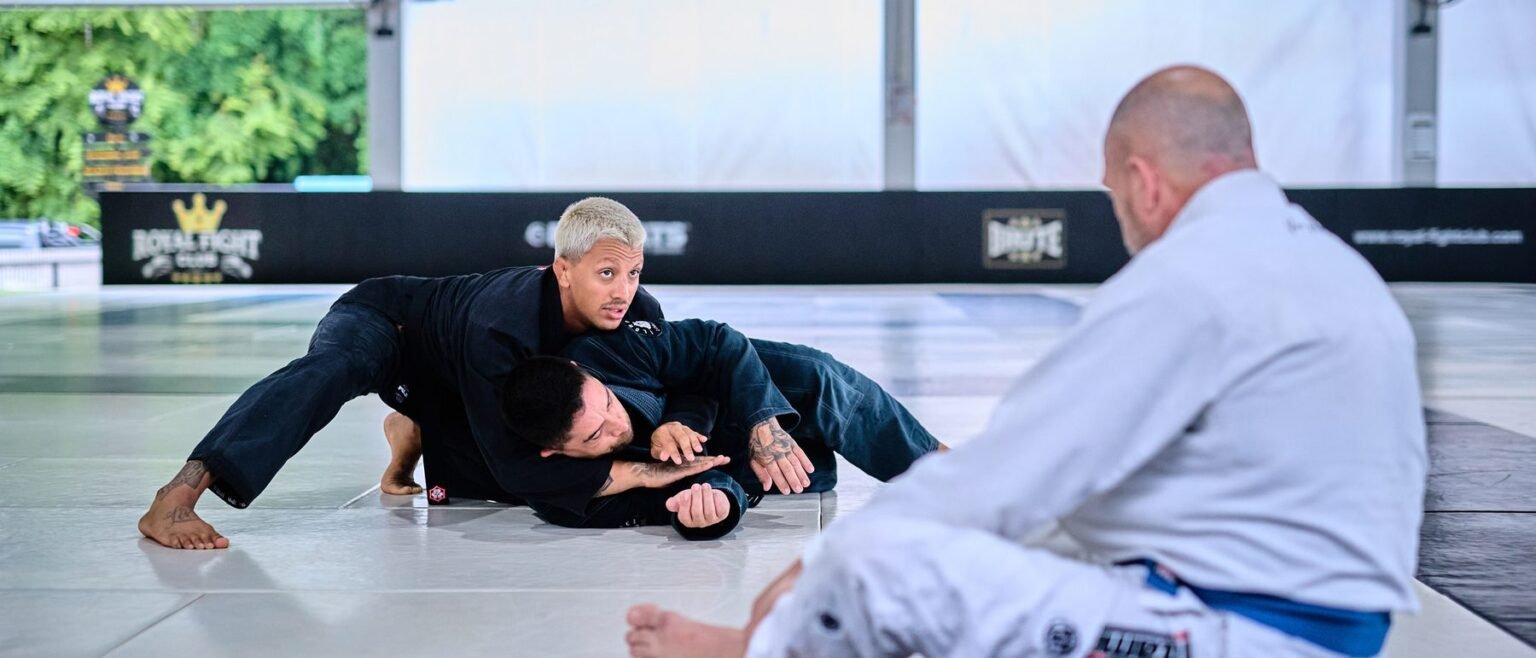 BJJ coach demonstrating a guard pass on the Fuji mats at Superpro Samui, Koh Samui